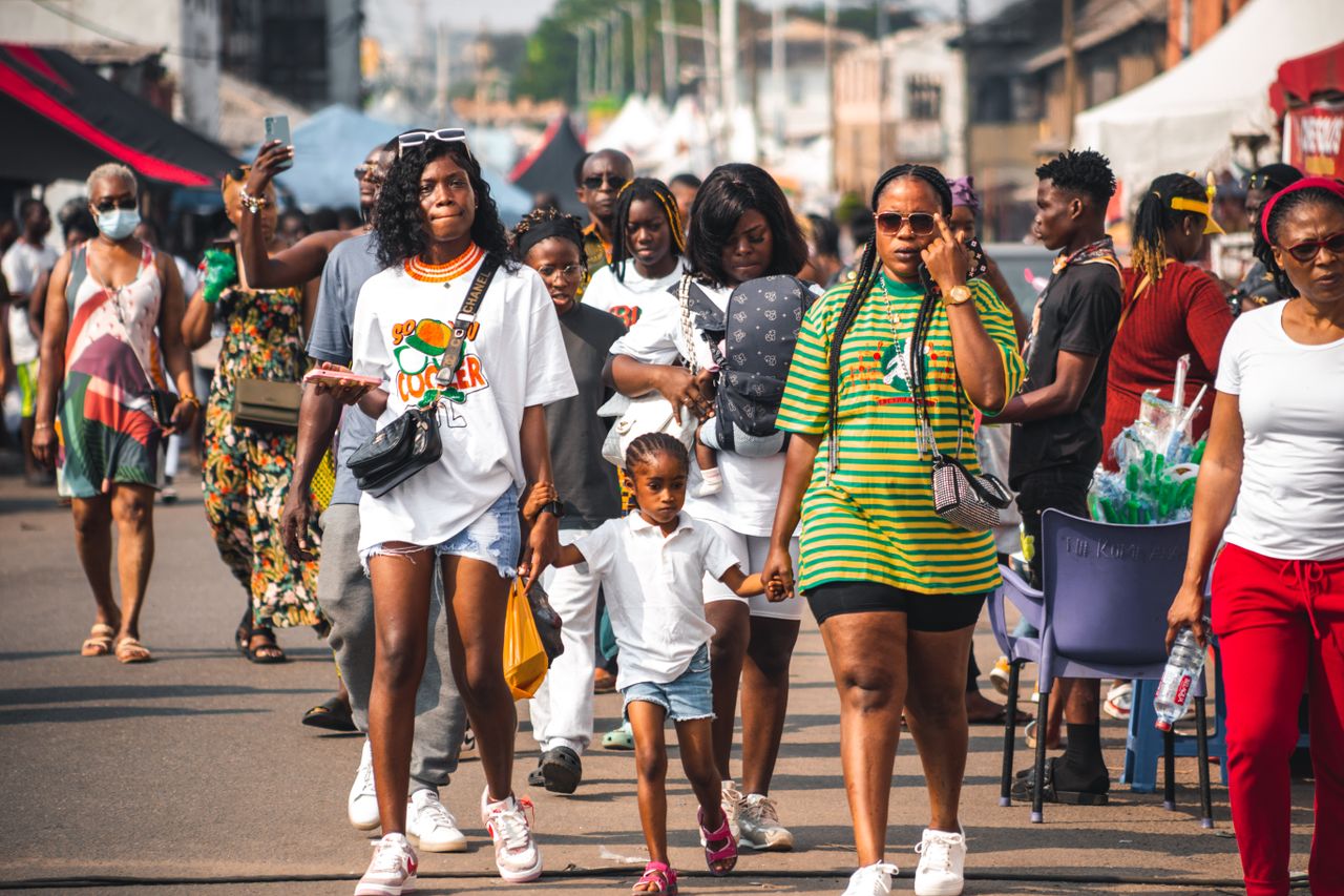 Home Diverse group of people walking on a bustling street in Accra, Ghana.
